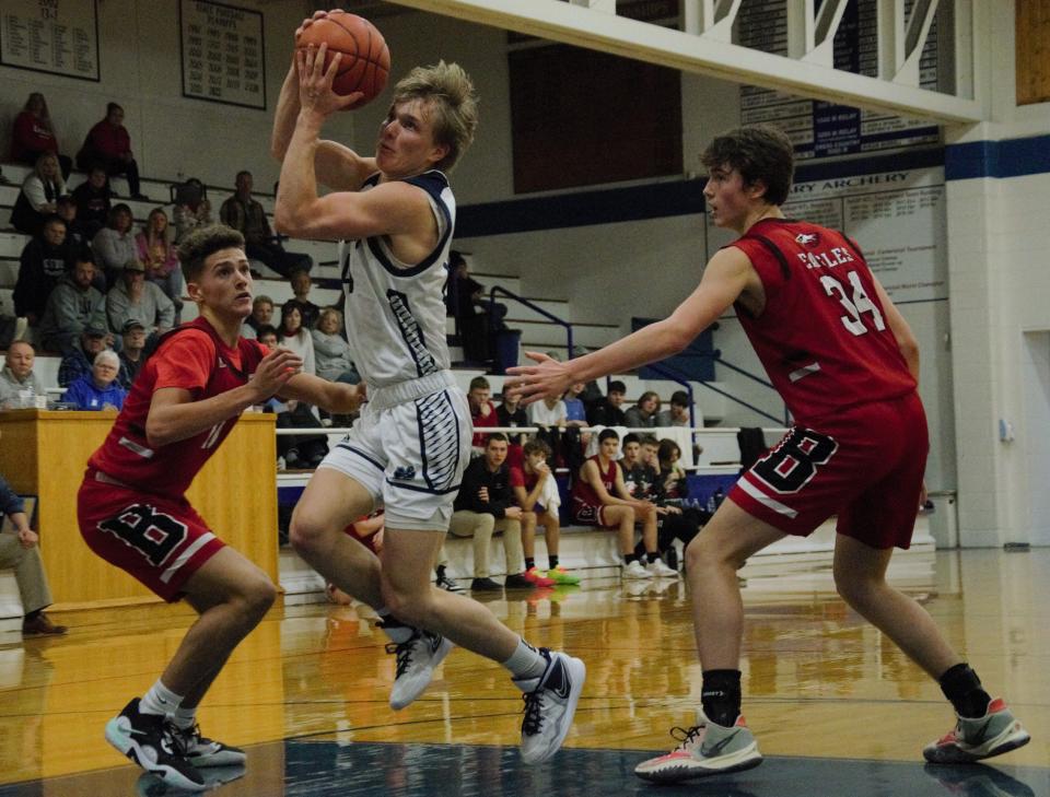 Brody Jeffers splits a double team during a boys basketball matchup between Gaylord St. Mary's and Bellaire on Tuesday, February 7/