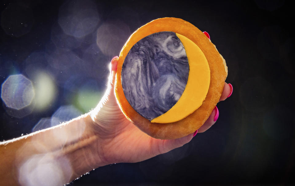 A donut with toppings representing an eclipse is displayed at the Donut Dude shop on Friday, March 8, 2024, in Liberty Township, Ohio. Businesses are capitalizing on the April 8, 2024 solar eclipse expected to dim skies across a generous stretch of North America. (Travel Butler County/RVP Photography via AP)