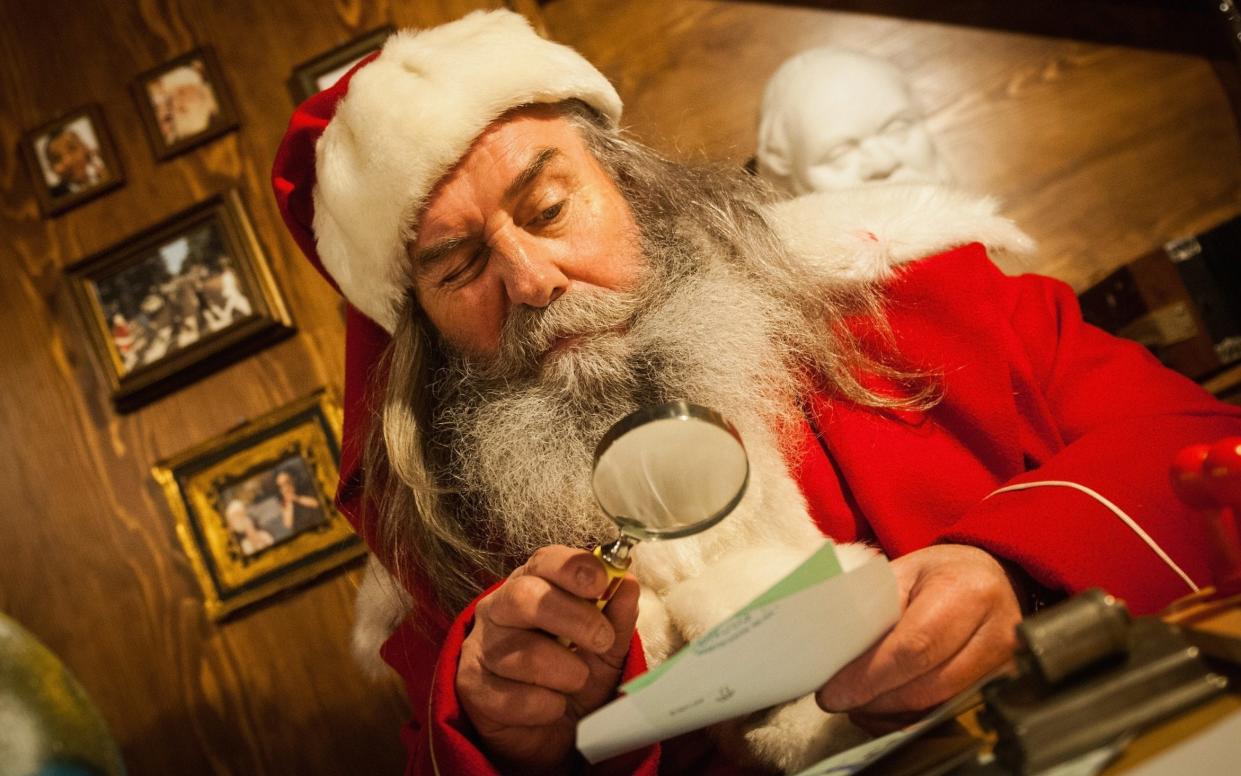 Father Christmas reads one of his letters - Getty Images Europe