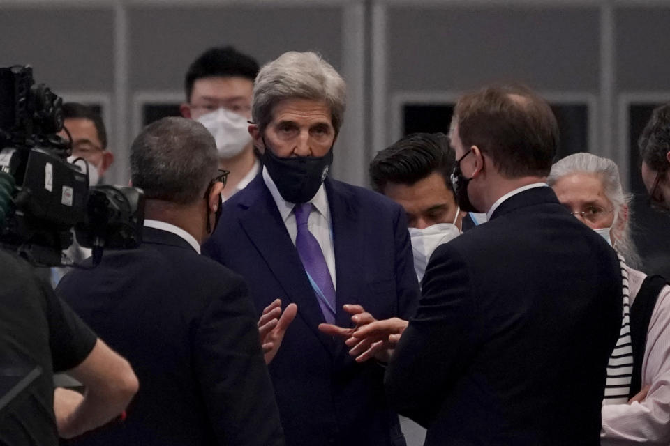 John Kerry, center, United States Special Presidential Envoy for Climate talks with Alok Sharma, left, President of the COP26 during a stocktaking plenary at the COP26 U.N. Climate Summit, in Glasgow, Scotland, Saturday, Nov. 13, 2021. Going into overtime, negotiators at U.N. climate talks in Glasgow are still trying to find common ground on phasing out coal, when nations need to update their emission-cutting pledges and, especially, on money.(AP Photo/Alberto Pezzali)