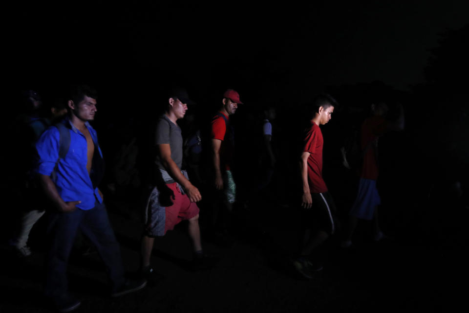 Central American migrants traveling with a caravan to the U.S. make their way to Mapastepec, Mexico, Wednesday, Oct. 24, 2018. After a day of rest to honor a fellow traveler who died on the road on Monday, the march continues through Mexico. (AP Photo/Moises Castillo)