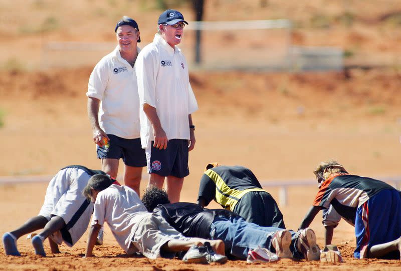 Australian cricketer Jones takes local aboriginal children through fitness drills during a kids ...
