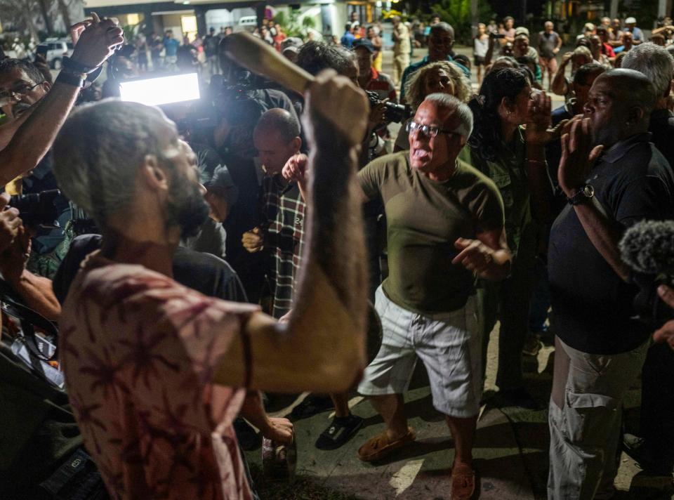 In this Oct. 2022 photo, demonstrators and government officials argue during a demonstration after six days of hurricane-related electric power blackouts.
