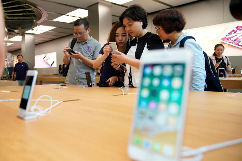 Customers look at Apple’s new iPhone 8 Plus after it goes on sale at an Apple Store in Shanghai, China September 22, 2017. REUTERS/Aly Song