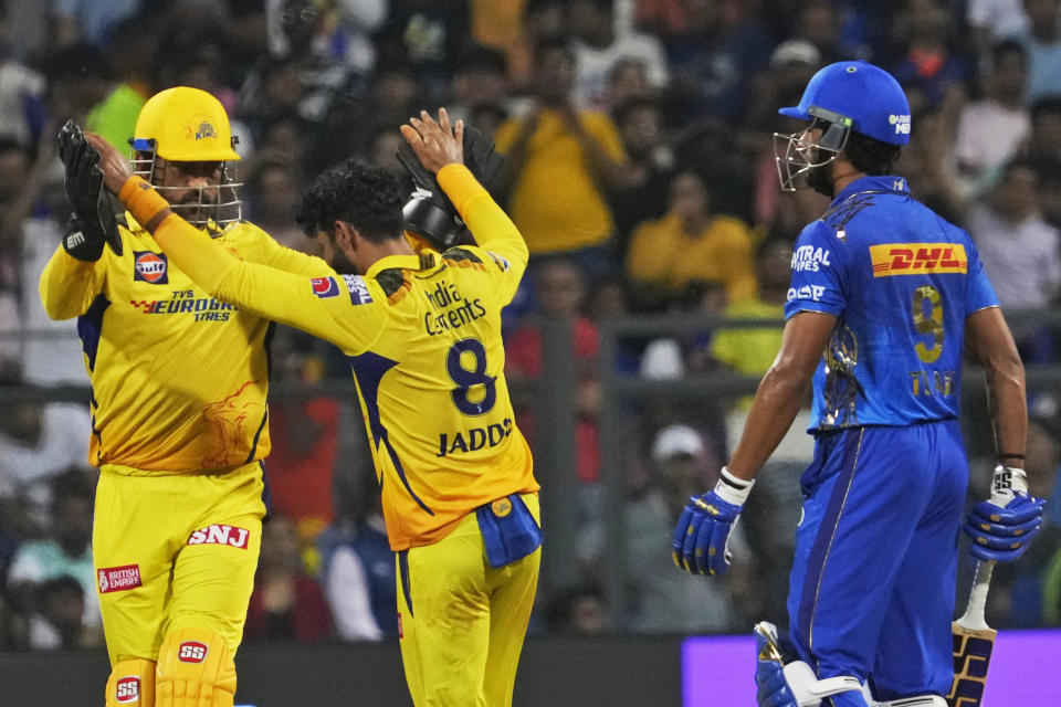 Chennai Super Kings' Ravindra Jadeja and Mahendra Singh Dhoni, left, celebrate the dismissal of Mumbai Indians' Tilak Varma during the Indian Premier League (IPL) cricket match between Mumbai Indians and Chennai Super Kings in Mumbai, India, Saturday, April 8, 2023. (AP Photo/Rajanish Kakade)