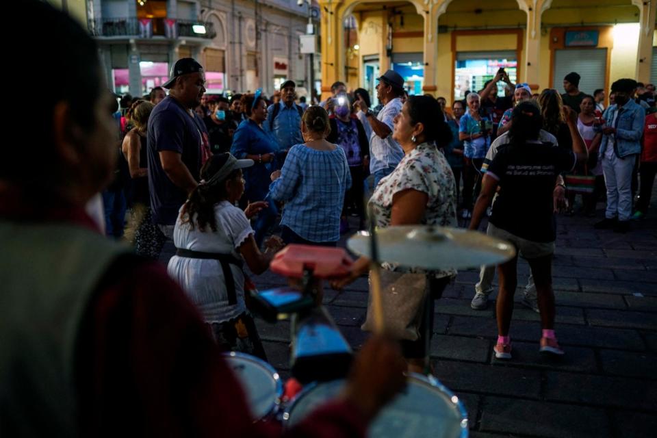 PHOTO: People dance at Liberty Square in San Salvador, El Salvador, Dec. 1, 2023. (Camilo Freedman/AFP via Getty Images)