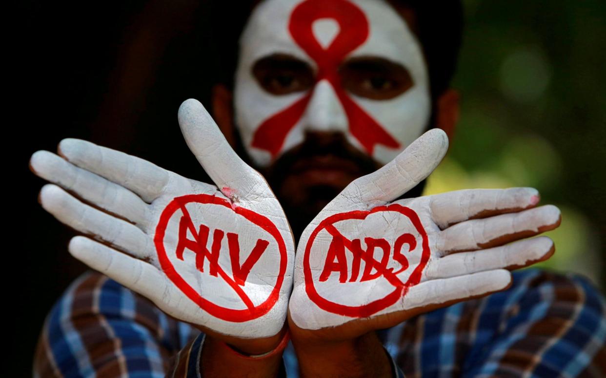 A student poses in India during an HIV/AIDS awareness campaign - REUTERS