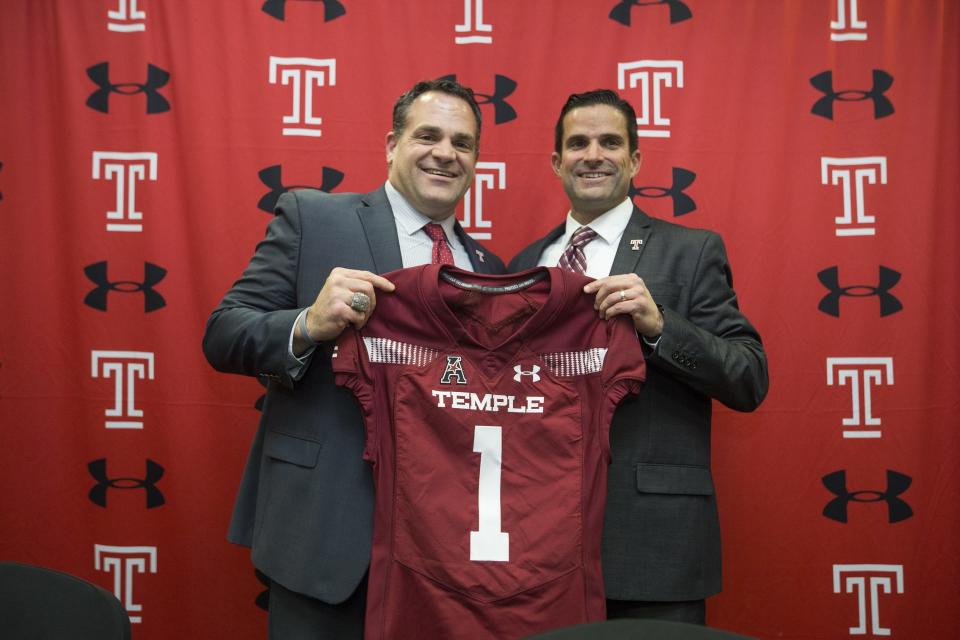 Manny Diaz (right) is introduced as Temple University's new football coach while holding up a jersey with Director of Athletics Dr. Patrick Kraft at the Liacouras Center in Philadelphia on Thursday. [CHARLES FOX /Philadelphia Inquirer]