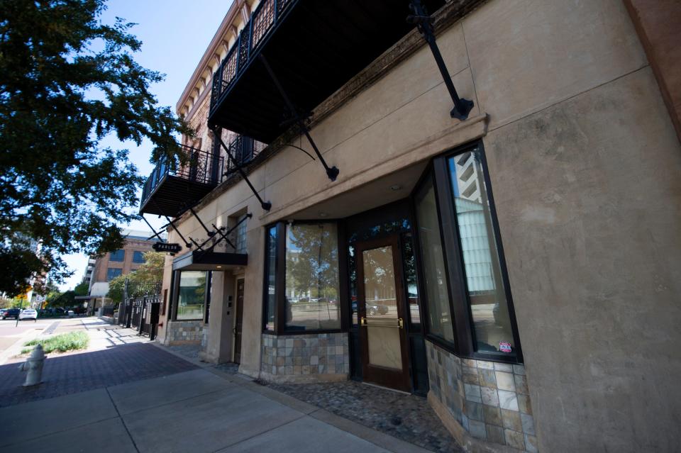 A storefront next to the temporarily-closed Parlor Market restaurant in the 100 block of East Capitol Street in downtown Jackson, Miss., has its windows covered with brown paper Tuesday, Oct. 11, 2022.  For years, Capitol Street in downtown Jackson has had empty storefronts, many with lease signs in the windows.