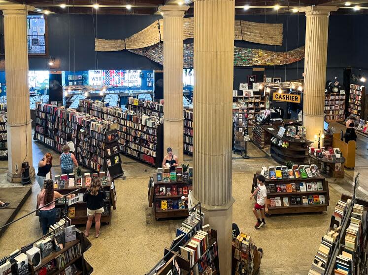 Visitors peruse through books and records inside of The Last Bookstore in Downtown Los Angeles.