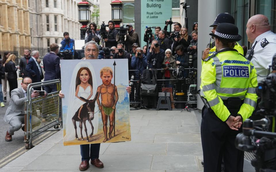 Kaya Mar with his political artwork outside court