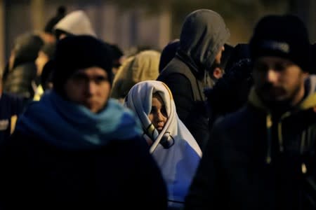 Venezuelan migrants queue to get their background criminal records outside a police office in Lima