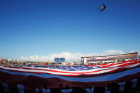 A B-52 flies over a giant American flag held in the infield during the national anthem prior to the NASCAR Sprint Cup Series Coca-Cola 600 at Charlotte Motor Speedway on May 27, 2012 in Concord, North Carolina. (Photo by Chris Graythen/Getty Images)