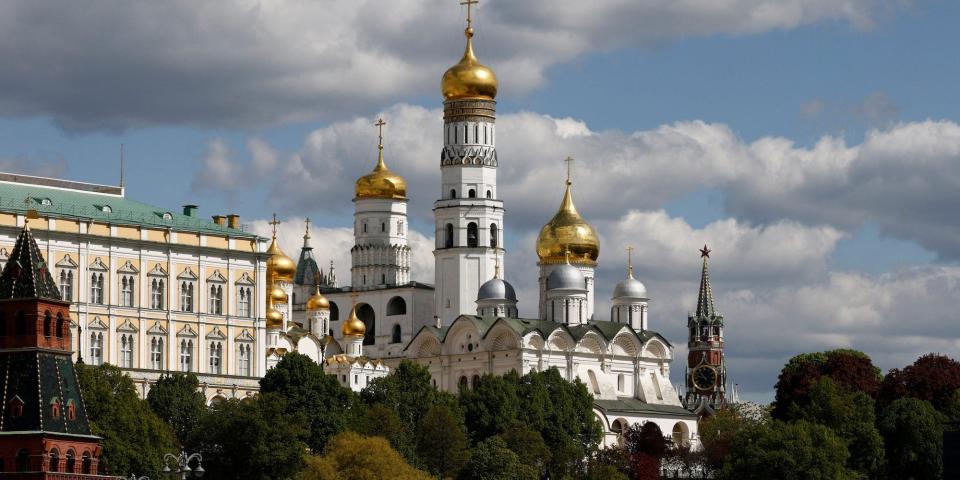 Armoured vehicles drive past the Kremlin wall after a military parade on Victory Day, with an empty sky, on May 9, 2023.