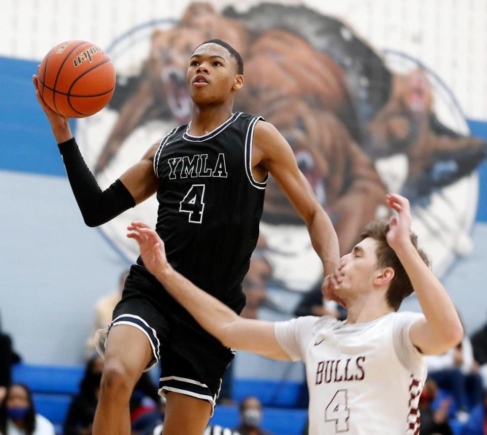 YMLA’s D’Monyae Davis (4) lays one in over Bridgeport point Kyler Sparks (4) during a 4A Region 1 bi-district basketball game at Brewer High School in Fort Worth, Texas, Monday, Feb. 22, 2021. YMLA led by 12 at the half way mark. (Special to the Star-Telegram Bob Booth)