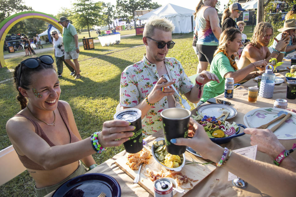 Festivalgoers are seen during Bonnaroots, a four course meal that benefits global organizations for hunger, presented by Eat for Equity at the Bonnaroo Music and Arts Festival on Thursday, June 16, 2022, in Manchester, Tenn. (Photo by Amy Harris/Invision/AP)