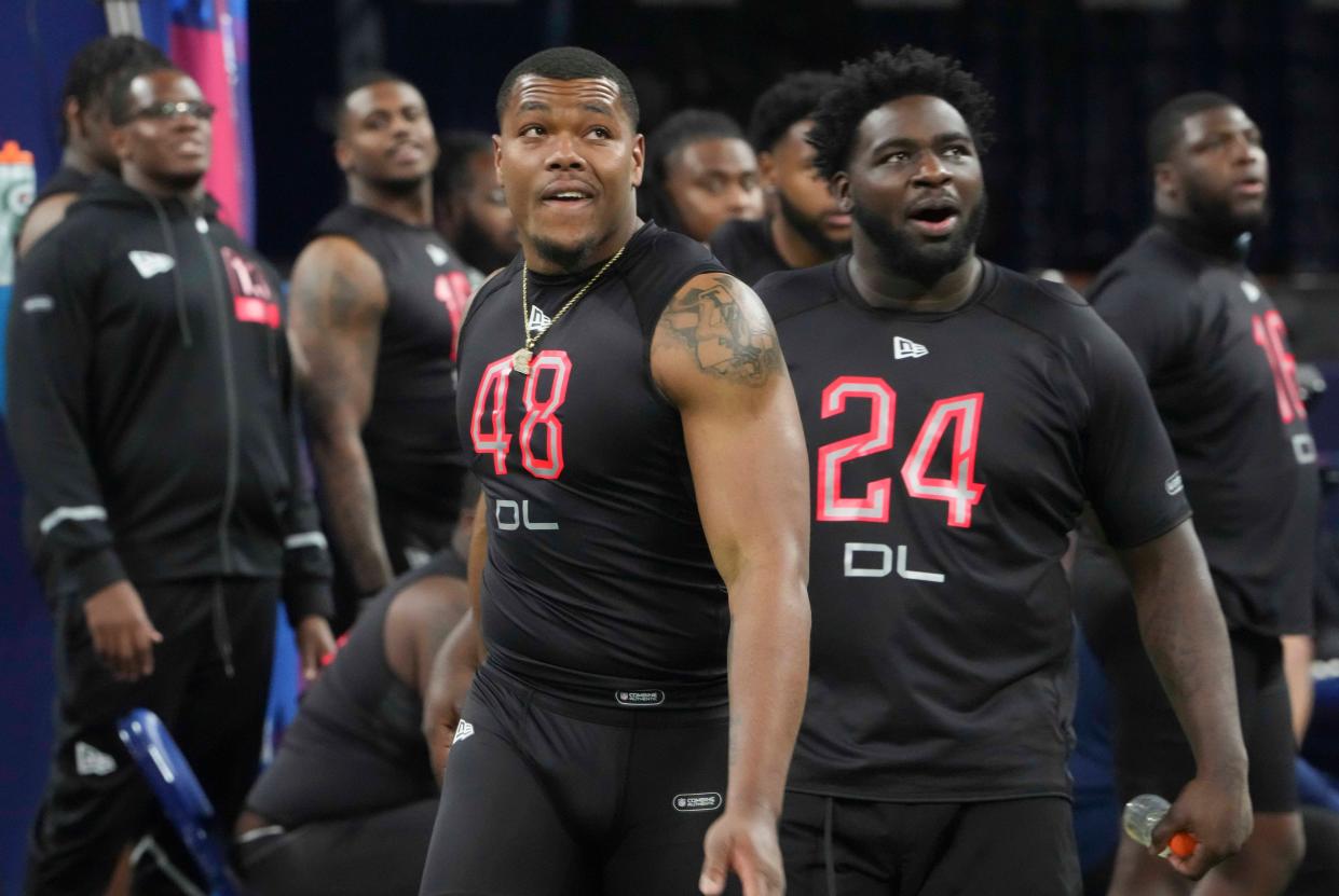 Mar 5, 2022; Indianapolis, IN, USA; Georgia defensive lineman Travon Walker (DL48) and Georgia defensive lineman Devonte Wyatt (DL24) react during drills at the 2022 NFL Scouting Combine at Lucas Oil Stadium. Kirby Lee-USA TODAY Sports