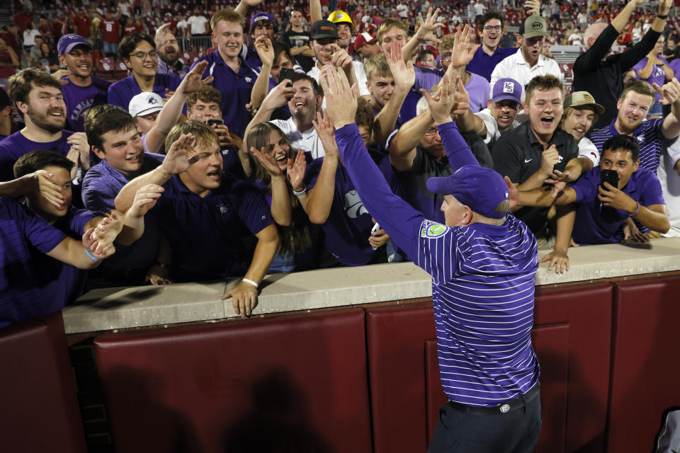 Kansas State coach Chris Klieman celebrates with fans after the team's 41-34 win over Oklahoma in an NCAA college football game Saturday, Sept. 24, 2022, in Norman, Okla. (AP Photo/Nate Billings)