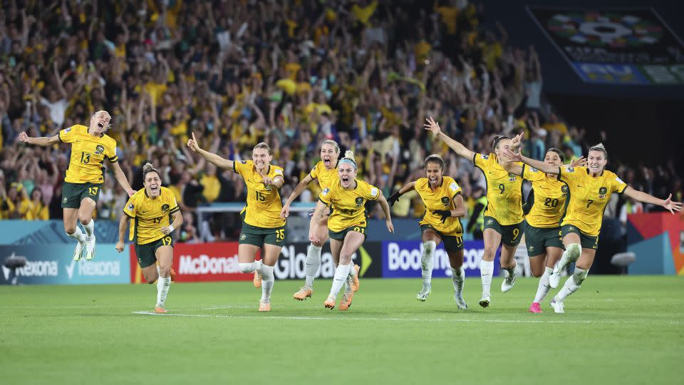 Australia players celebrate after winning their quarterfinal match against France in Brisbane, August 12. - Tertius Pickard/AP