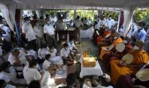 Family members of Sri Lankan factory manager Priyantha Kumara who was lynched by a Muslim mob in Pakistan for alleged blasphemy take part in religious rites during his burial in Colombo, Sri Lanka, Wednesday, Dec. 8, 2021. (AP Photo/Eranga Jayawardena)