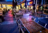 Chairs and tables stand outside a restaurant in Frankfurt, Germany, Wednesday, Oct. 28, 2020. (AP Photo/Michael Probst)