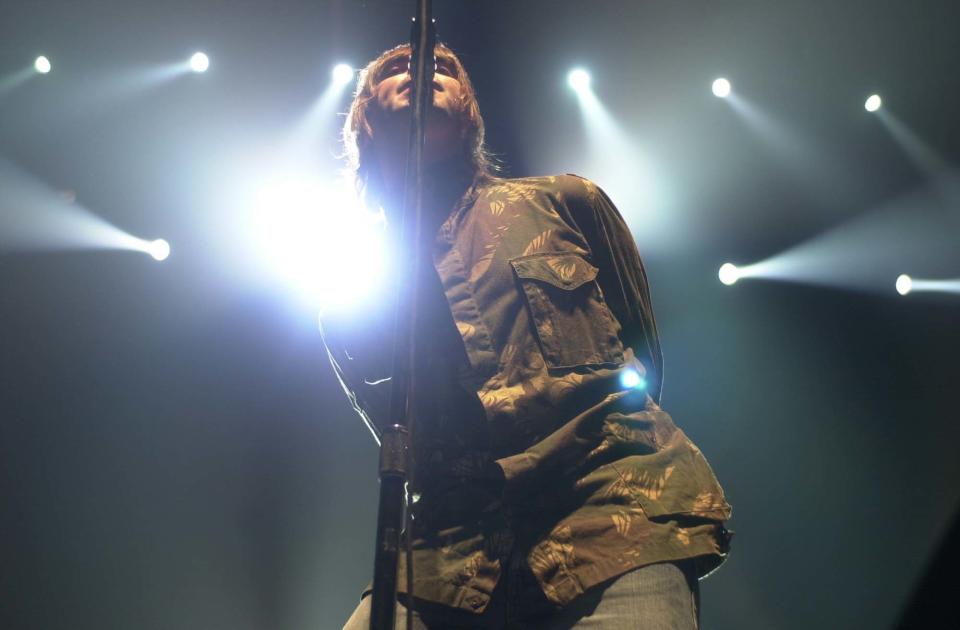 Oasis singer Liam Gallagher performing on stage at the Point Theatre Dublin, Republic of Ireland.