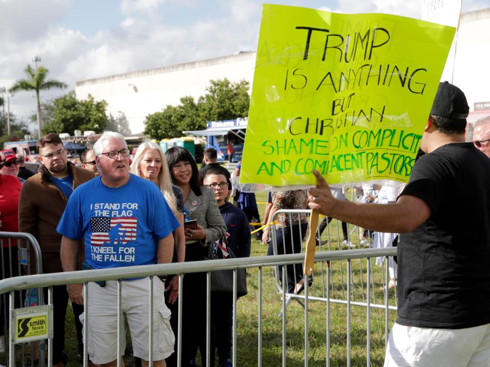 trump rally evangelical christians protest sign