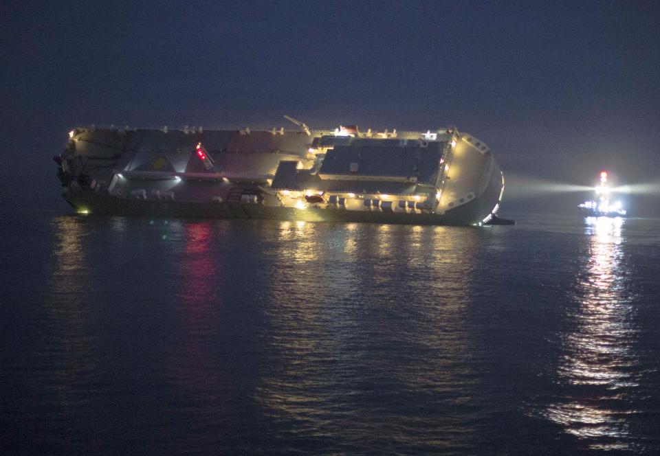 The cargo ship Hoegh Osaka lies on its side after running aground on Saturday evening in the Solent estuary, near Southampton in southern England
