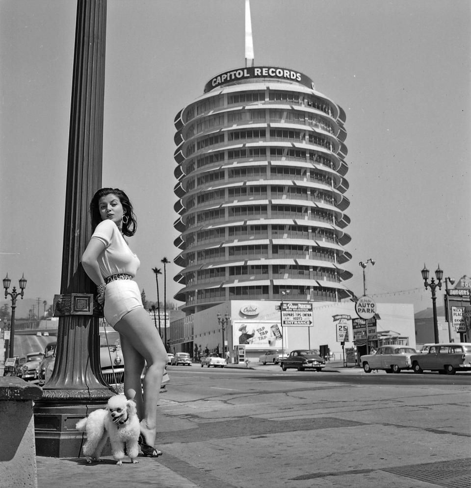 <p>Who wears short shorts? Joan Bradshaw! Posing in front of Capitol Records with a cute pup, she starred in a few films but is most well-known for her producing career. </p><p><strong>RELATED:</strong> <a href="https://www.goodhousekeeping.com/life/entertainment/g3775/it-girls-through-the-years/" rel="nofollow noopener" target="_blank" data-ylk="slk:Find Out Who the Hollywood "It Girl" Was the Year You Were Born;elm:context_link;itc:0;sec:content-canvas" class="link ">Find Out Who the Hollywood "It Girl" Was the Year You Were Born</a></p>