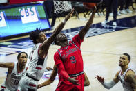 St. John's guard Rasheem Dunn (3) scores against Connecticut forward Isaiah Whaley (5) in the second half of an NCAA college basketball game in Storrs, Conn., Monday, Jan. 18, 2021. (David Butler II/Pool Photo via AP)