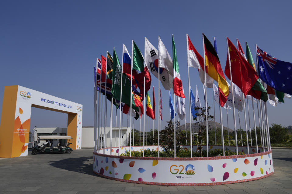 A buggy moves past a display of flags of participating countries at the venue of G-20 financial conclave on the outskirts of Bengaluru, India, Wednesday, Feb. 22, 2023. Top financial leaders from the Group of 20 leading economies are gathering in the south Indian technology hub of Bengaluru to tackle challenges to global growth and stability. India is hosting the conclave for the first time in 20 years. (AP Photo/Aijaz Rahi)