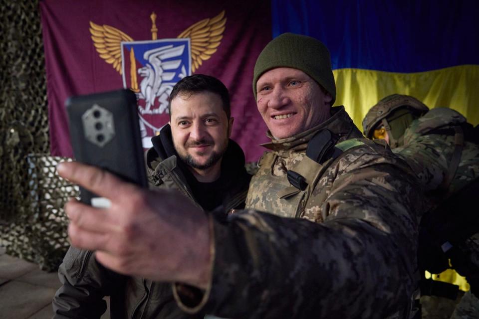 A Ukrainian soldier takes a selfie with President Zelensky during his visit to Sloviansk, Donbas on Tuesday (AP)