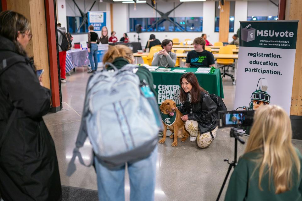 MSU students and community members take photos with ÒZeke the WonderdogÓ during a voter registration event at Michigan State University on Feb. 6, 2024.