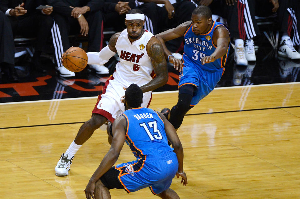 MIAMI, FL - JUNE 17: LeBron James #6 of the Miami Heat drives in the first quarter against James Harden #13 and Kevin Durant #35 of the Oklahoma City Thunder in Game Three of the 2012 NBA Finals on June 17, 2012 at American Airlines Arena in Miami, Florida. NOTE TO USER: User expressly acknowledges and agrees that, by downloading and or using this photograph, User is consenting to the terms and conditions of the Getty Images License Agreement. (Photo by Ronald Martinez/Getty Images)