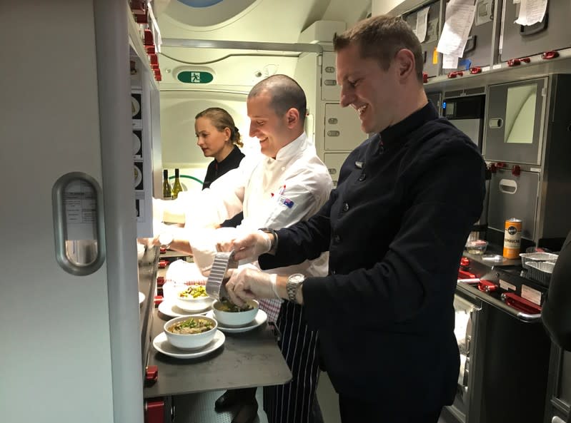 Crew members prepare food on board Qantas flight QF7879, flying direct from London to Sydney