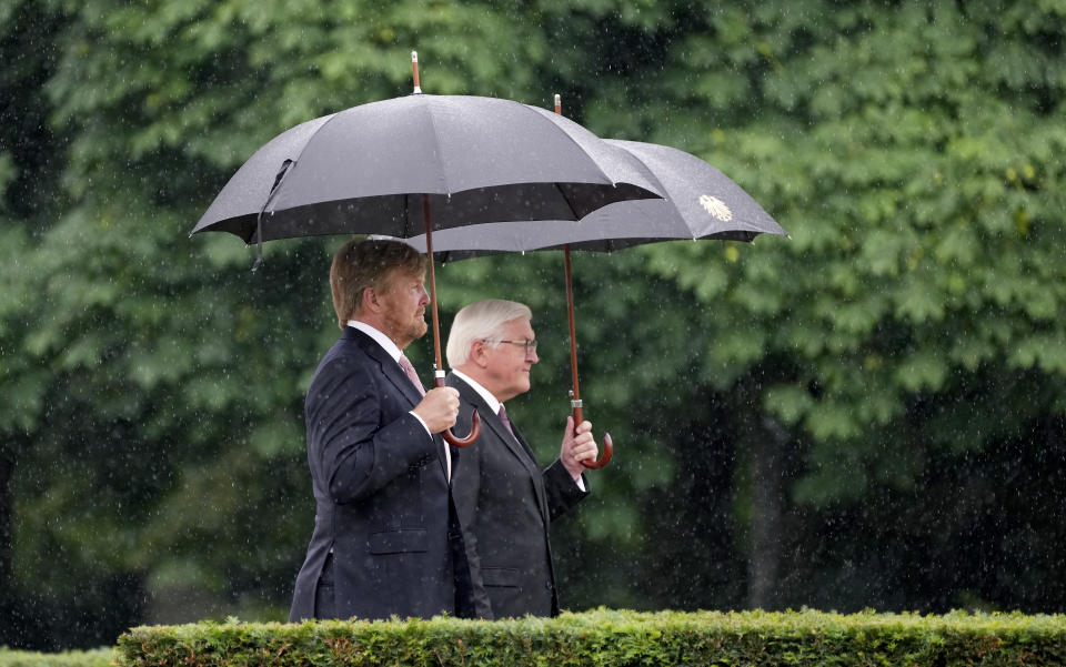 German President Frank-Walter Steinmeier, right, and Dutch King Willem-Alexander, left, attend a military welcome ceremony as part of a meeting in Berlin, Germany, Monday, July 5, 2021. The Royals arrived in Germany for a three-day visit that was delayed from last year because of the coronavirus pandemic. (AP Photo/Michael Sohn)