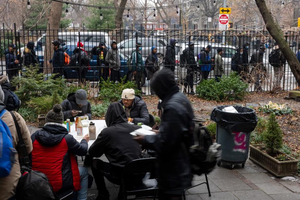 PHOTO: Newly arrived migrants receive an afternoon meal from Trinity Services and Food For the Homeless, across from Tompkins Square Park on January 24, 2024 in New York City. (Spencer Platt/Getty Images)