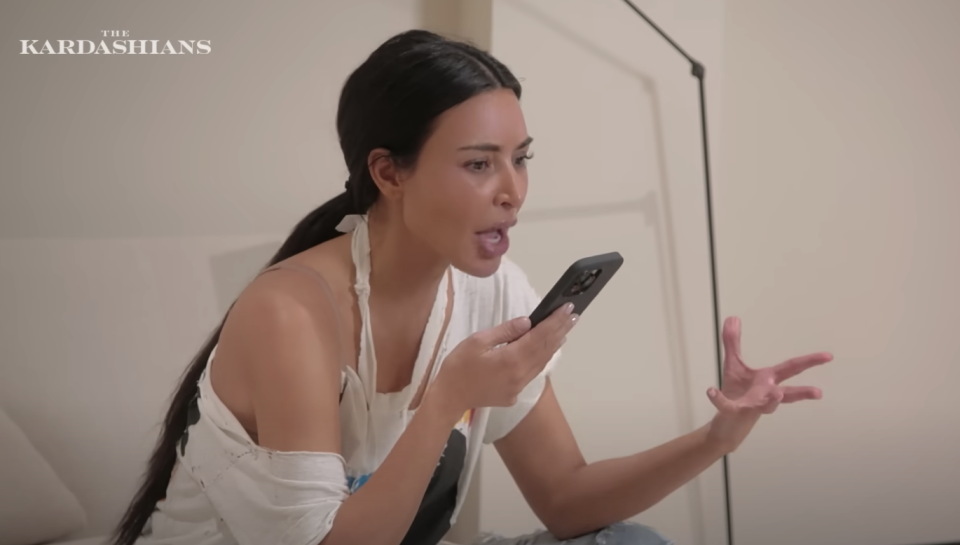 Close-up of Kim talking into a phone