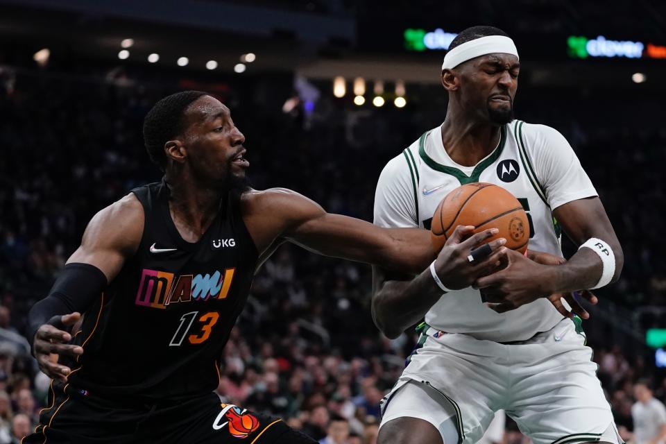 Milwaukee Bucks' Bobby Portis and Miami Heat's Bam Adebayo battle for the ball during the first half of an NBA basketball game Wednesday, March 2, 2022, in Milwaukee . (AP Photo/Morry Gash)