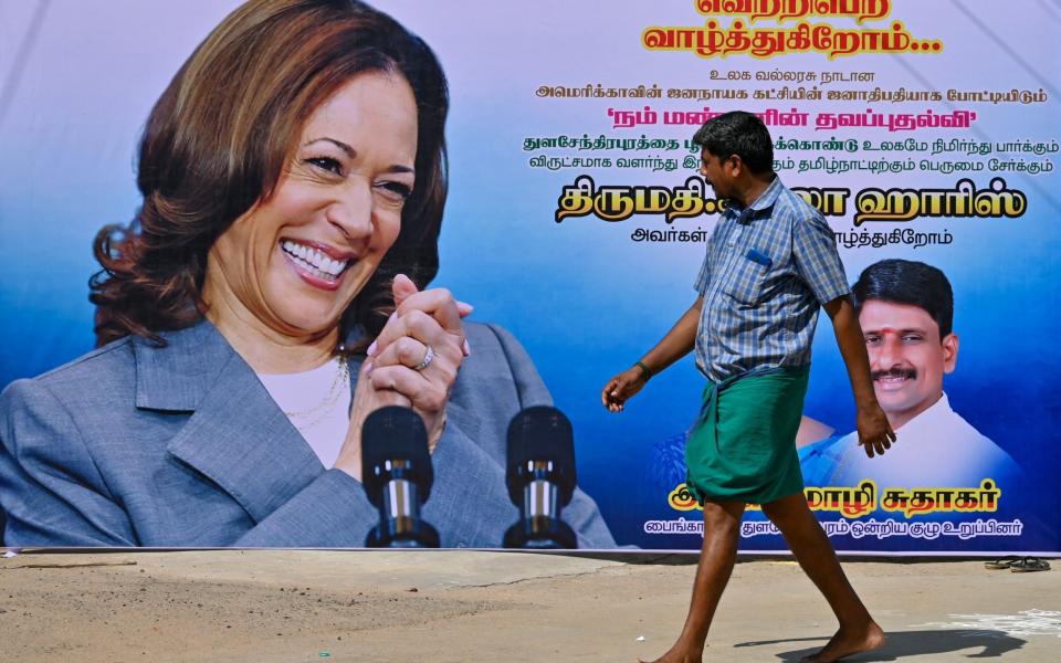 A local walks past a poster of Kamala Harris in Thulasendrapuram in the southern Indian state of Tamil Nadu