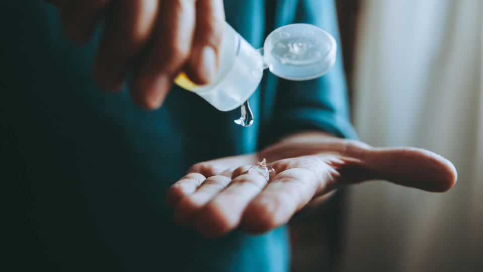 A man washing hands with alcohol sanitizer against virus.