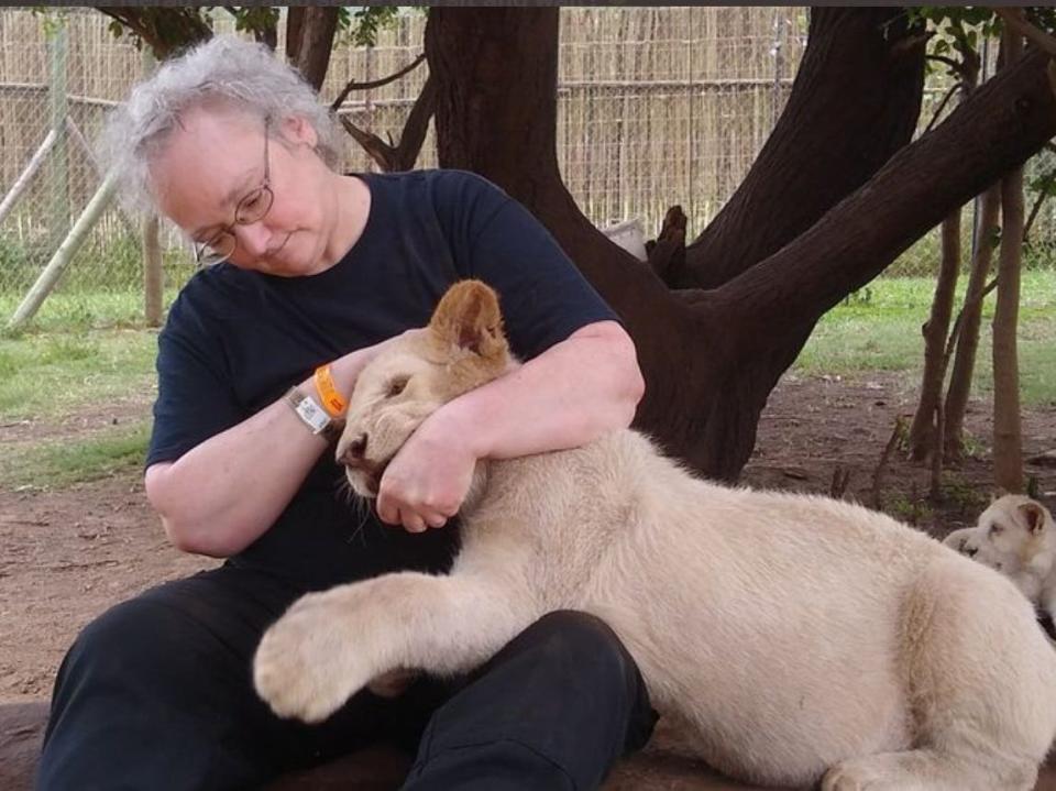 Shava Nerad plays with a lion cub during a vacation in South Africa