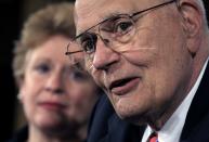 FILE- In this Sept. 24, 2008 file photo, House Energy and Commerce Committee Chairman Rep. John Dingell, D-Mich., right, accompanied by Sen. Debbie Stabenow, D-Mich., meets with reporters on Capitol Hill in Washington. Dingell, the longest-serving member of Congress in American history who mastered legislative deal-making and was fiercely protective of Detroit's auto industry, has died at age 92. Dingell, who served in the U.S. House for 59 years before retiring in 2014, died Thursday, Feb. 7, 2019, at his home in Dearborn, said his wife, Congresswoman Debbie Dingell.(AP Photo/Lauren Victoria Burke, File)