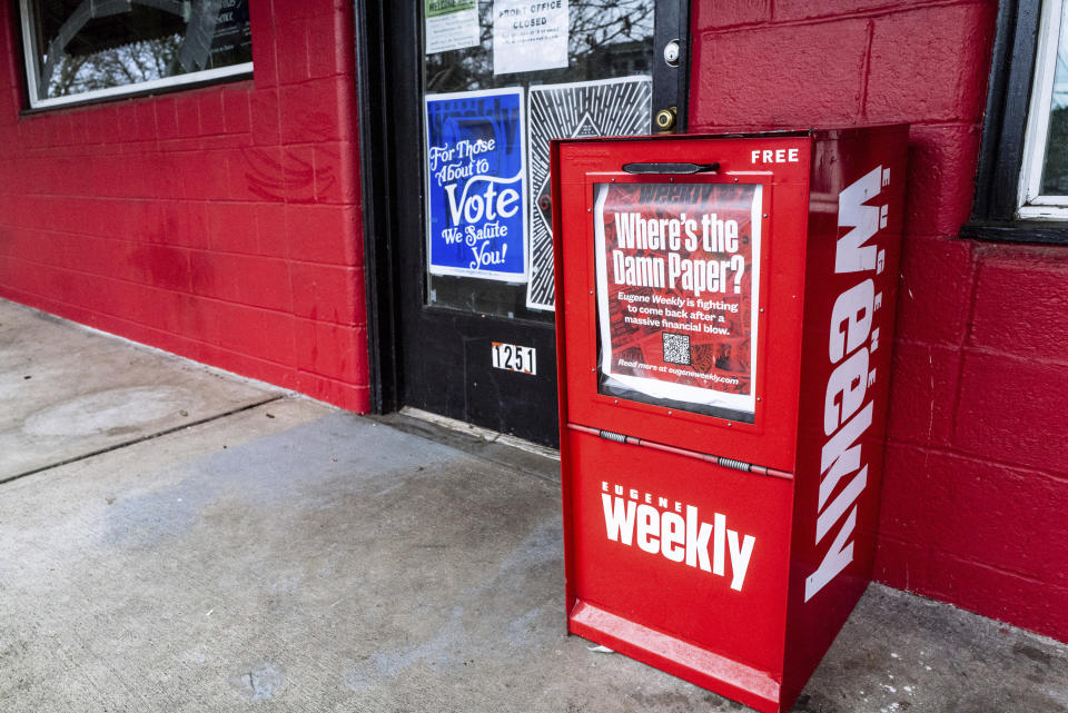 A red Eugene Weekly newspaper distributor box stands outside its office in Eugene, Ore. on Friday, Dec. 29, 2023. The weekly newspaper had to lay off its entire staff three days before Christmas and halt print because its funds were embezzled by a former employee, its editor said. The Eugene police are investigating and the paper's owners have hired forensic accountants to piece together what happened. (Todd Cooper via AP)