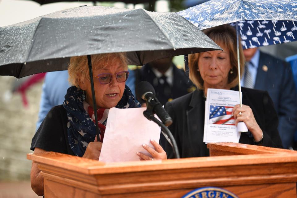 Loren Rosenthal of Woodland Park, the wife of Richard D. Rosenthal who died on 9/11, reads out names as her sister-in-law Audrey Model of Florida, stands by during the 9/11 Memorial Ceremony at Overpeck County Park in Leonia, Sunday on 09/11/22. 