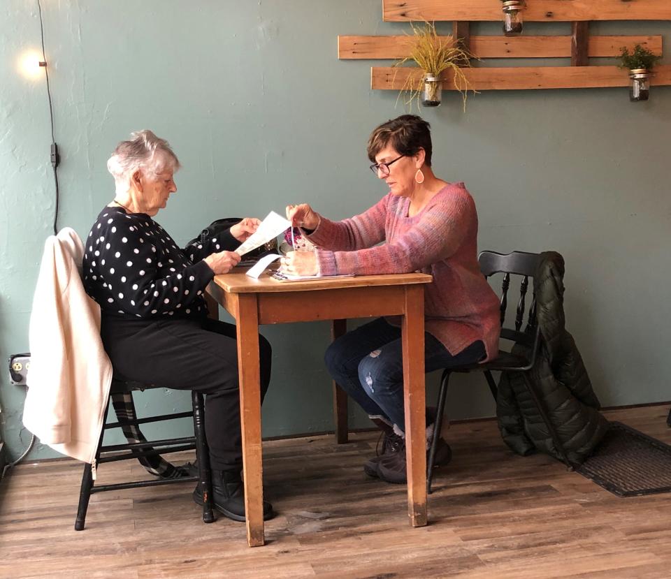 Mary Jane Valentino and Arlene Eddington decide on breakfast at the Local Palate in Phelps.