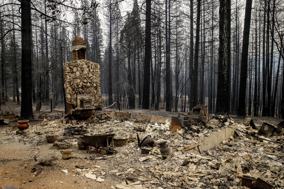 A chimney is left standing after a property was destroyed by the Caldor Fire in Grizzly Flats, Calif., on Wednesday, Aug. 18, 2021. (AP Photo/Ethan Swope)