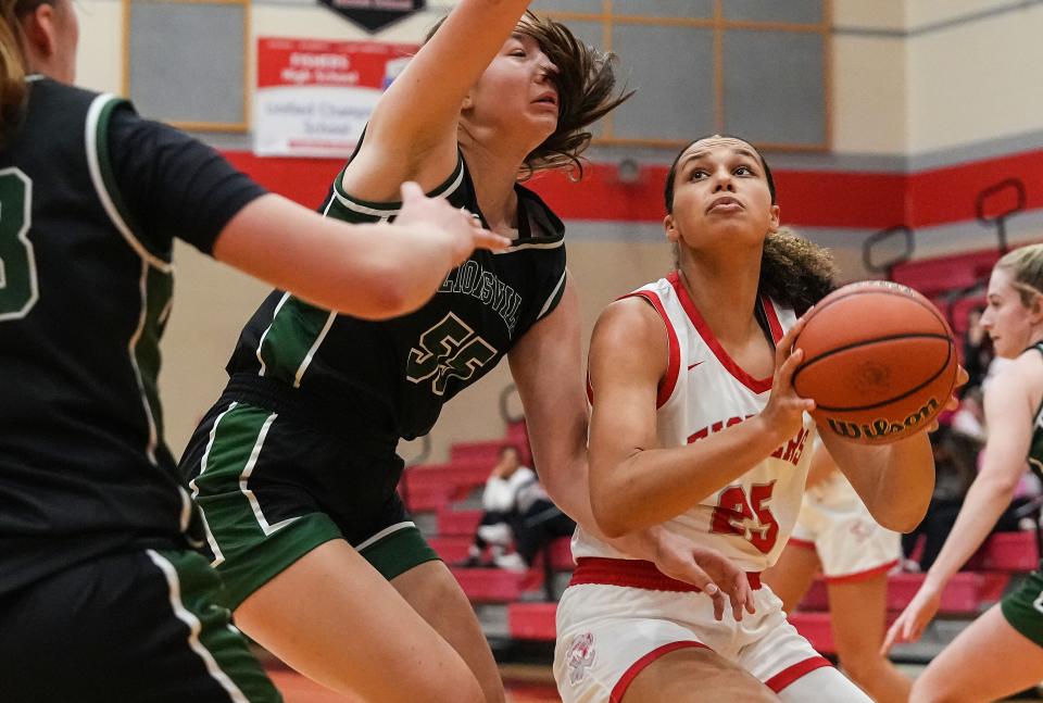 Fishers Tigers Nevaeh Dickman (25) rushes up the court against Zionsville Eagles forward Brooke Karesh (55) on Tuesday, Nov. 21, 2023, during the game at Fishers High School in Fishers. The Fishers Tigers defeated the Zionsville Eagles, 46-38.