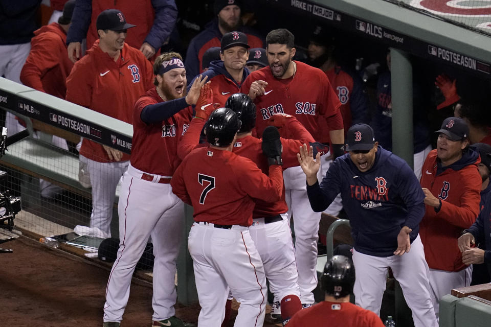 Boston Red Sox manager Alex Cora celebrates Boston Red Sox's Kyle Schwarber's grand slam home run during the second inning in Game 3 of baseball's American League Championship Series Monday, Oct. 18, 2021, in Boston. (AP Photo/Charles Krupa)