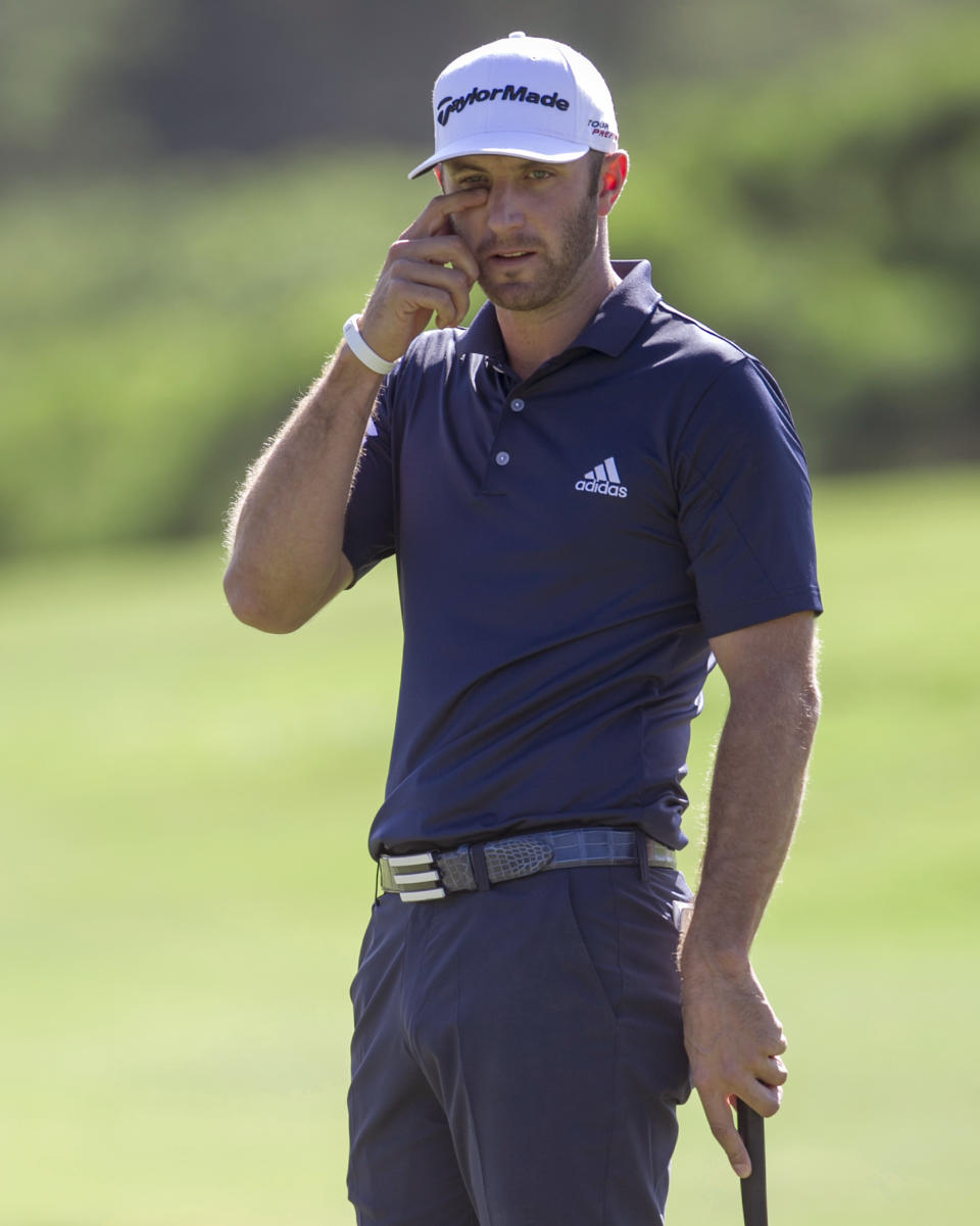 Dustin Johnson reacts to a missed putt on the first green during the final round of the Tournament of Champions golf tournament, Monday, Jan. 6, 2014, in Kapalua, Hawaii. (AP Photo/Marco Garcia)